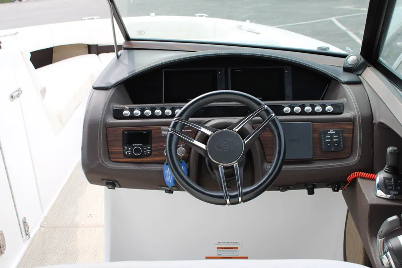  Yacht Photos Pics Dashboard of a 2020 Cobalt R30 boat with steering wheel and control panel.