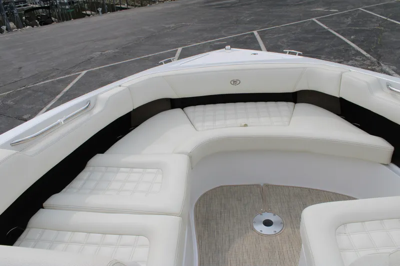 Yacht Photos Pics 2020 Cobalt R30 boat with white cushioned seating in a parking lot.