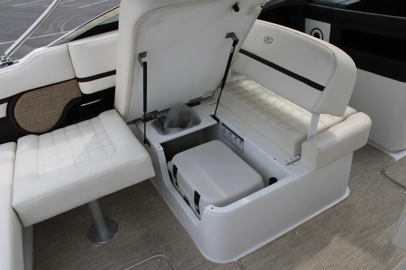  Yacht Photos Pics 2020 Cobalt R30 boat interior with open storage compartment and white seating.