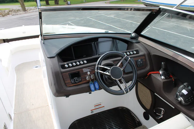  Yacht Photos Pics 2020 Cobalt R30 boat dashboard with steering wheel and control panel.