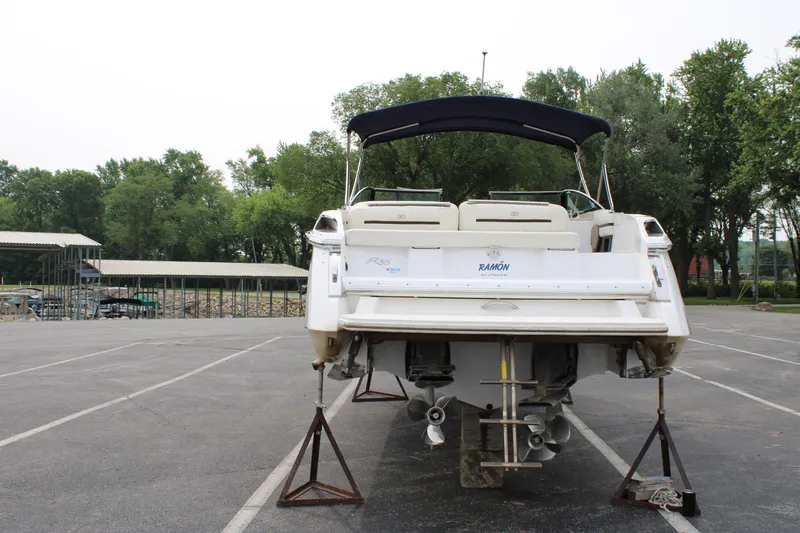  Yacht Photos Pics 2020 Cobalt R30 boat on stands in a parking lot, surrounded by trees.