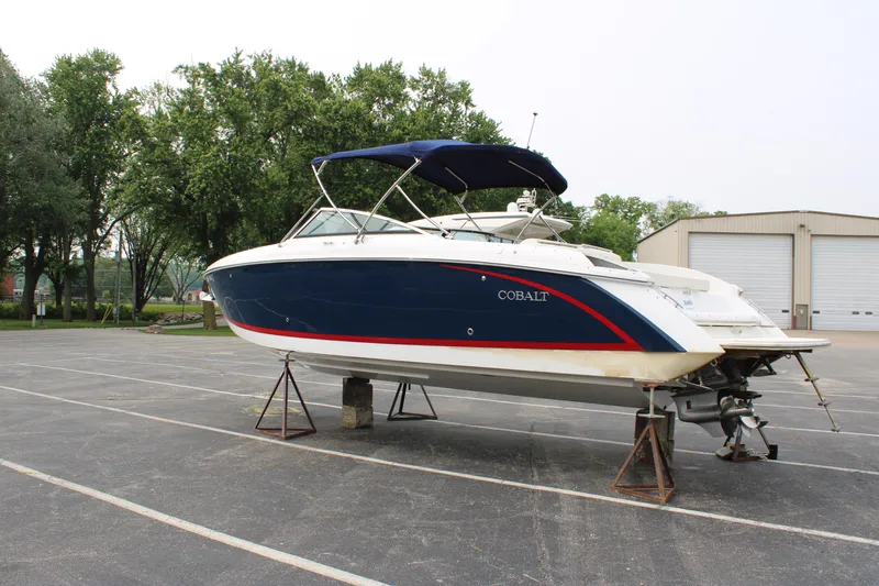  Yacht Photos Pics 2020 Cobalt R30 boat on stands in a parking lot, blue and white design.