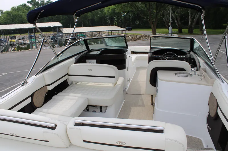  Yacht Photos Pics 2020 Cobalt R30 boat interior with white seating and steering wheel, docked outdoors.