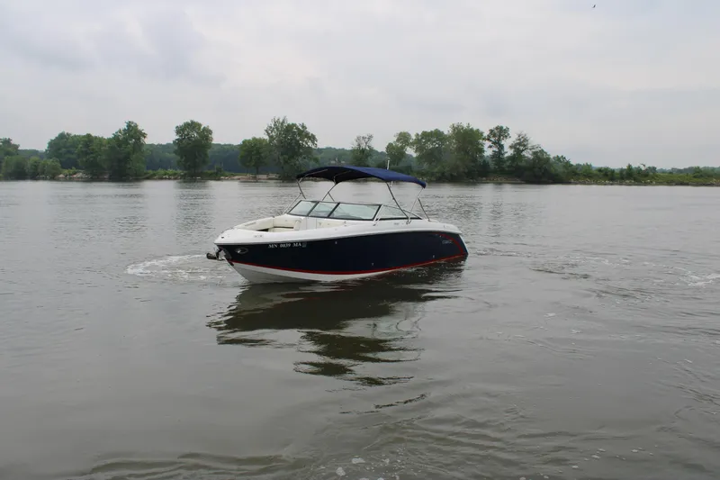  Yacht Photos Pics 2020 Cobalt R30 boat cruising on a calm lake with trees in the background.