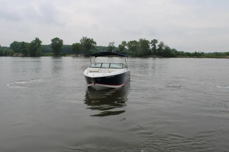  Yacht Photos Pics 2020 Cobalt R30 boat on a calm lake with trees in the background.