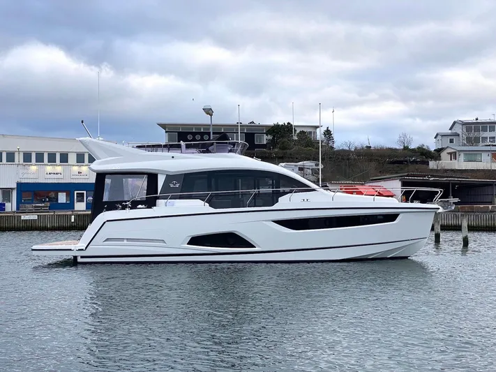 Sealine F430 Yacht Photos Pics 2025 Sealine F430 yacht docked in a marina, showcasing sleek design and modern architecture.