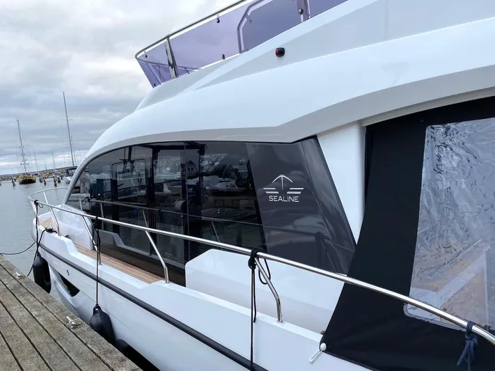 Sealine F430 Yacht Photos Pics 2025 Sealine F430 yacht docked at a marina, showcasing sleek design and modern features.