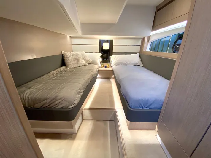 Sealine F430 Yacht Photos Pics 2025 Sealine F430 yacht cabin with twin beds, modern design, and ambient lighting.