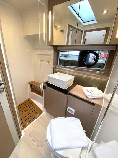 Sealine F430 Yacht Photos Pics Luxurious bathroom in 2025 Sealine F430 yacht with modern fixtures and skylight.