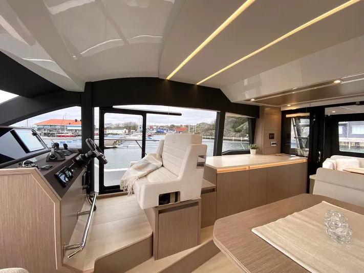 Sealine F430 Yacht Photos Pics Luxurious interior of 2025 Sealine F430 yacht with modern helm and seating area.