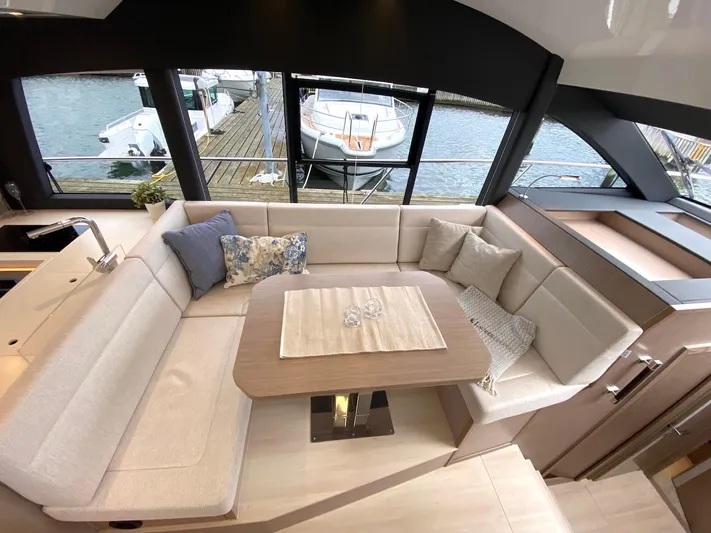 Sealine F430 Yacht Photos Pics Luxurious interior of 2025 Sealine F430 yacht with elegant seating and waterfront view.