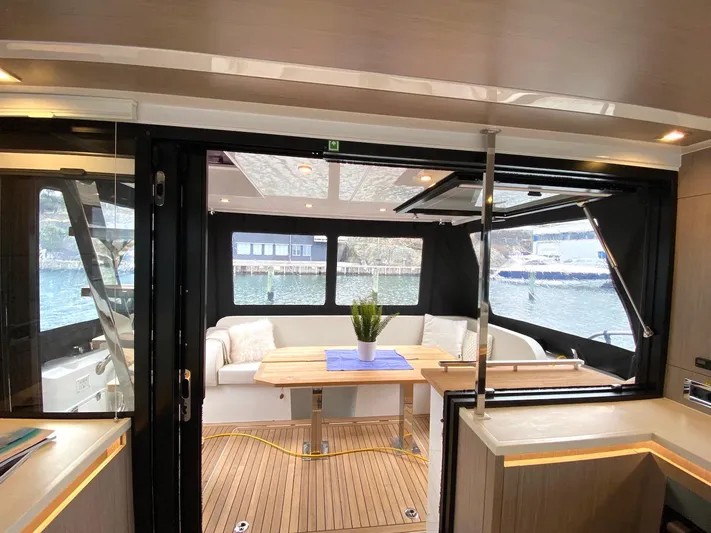 Sealine F430 Yacht Photos Pics Interior of 2025 Sealine F430 yacht with modern seating and wooden flooring.