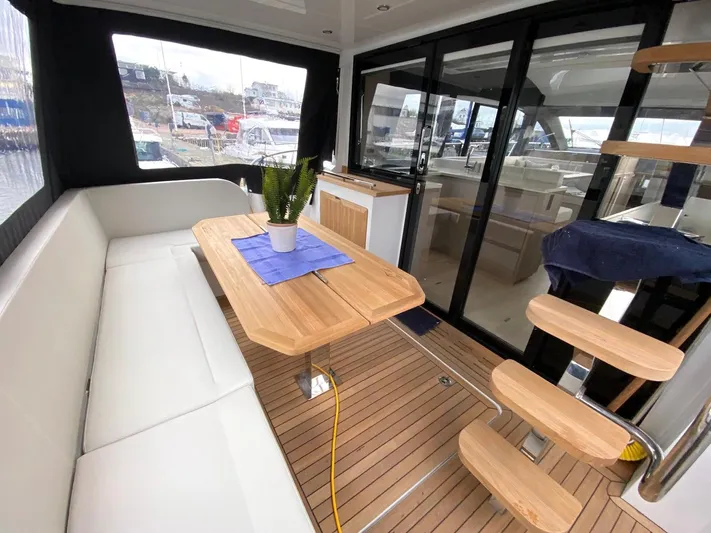 Sealine F430 Yacht Photos Pics Luxurious 2025 Sealine F430 yacht interior with wooden table, white seating, and modern design.