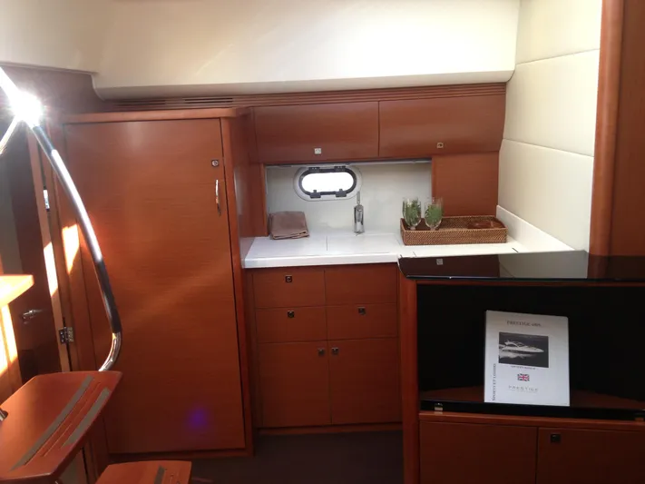  Yacht Photos Pics Luxurious interior of 2012 Prestige 440S yacht with wooden cabinetry and modern amenities.