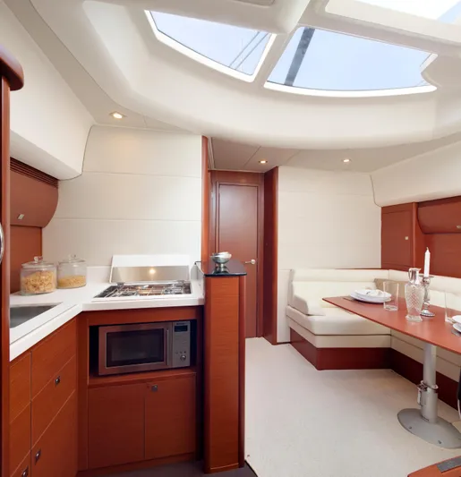  Yacht Photos Pics Luxurious interior of 2012 Prestige 440S yacht with modern kitchen and dining area.