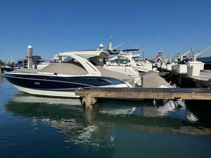 Sunny No Showers Yacht Photos Pics 2023 Formula 350 Crossover Bowrider OB docked at marina under clear blue sky.