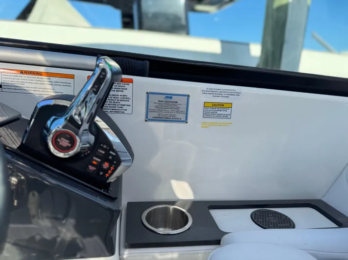 Sunny No Showers Yacht Photos Pics Control panel of 2023 Formula 350 Crossover Bowrider OB with cup holder and warning labels.