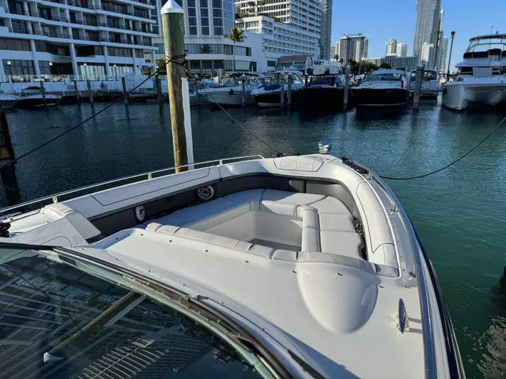 Sunny No Showers Yacht Photos Pics 2023 Formula 350 Crossover Bowrider OB docked in a marina with cityscape background.