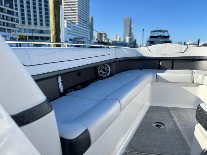 Sunny No Showers Yacht Photos Pics 2023 Formula 350 Crossover Bowrider OB interior with sleek seating and urban skyline backdrop.