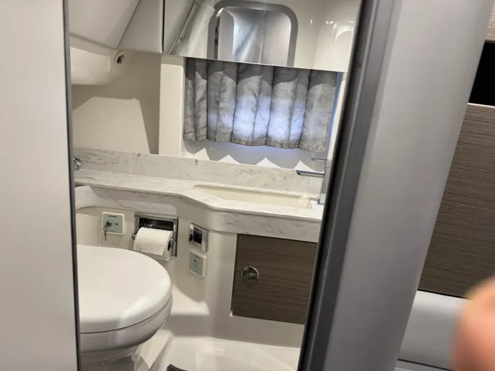 Sunny No Showers Yacht Photos Pics 2023 Formula 350 Crossover Bowrider OB bathroom interior with modern fixtures and window curtain.