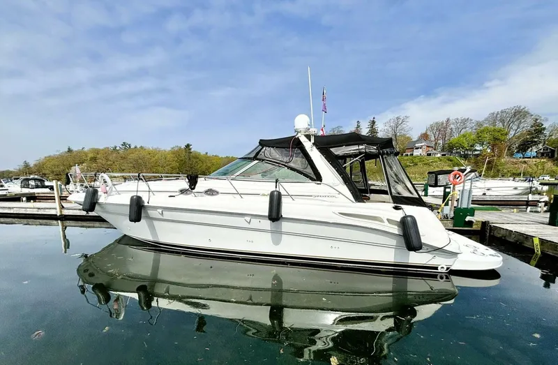  Yacht Photos Pics 2000 Sea Ray 410 Sundancer yacht docked in a serene marina setting.