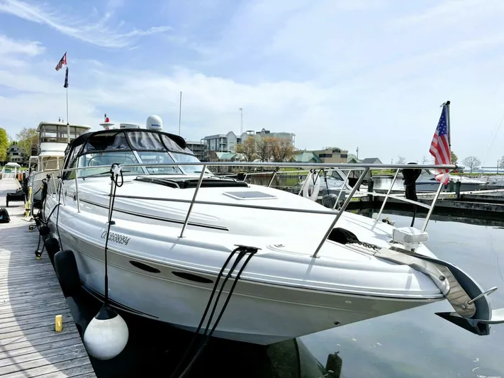  Yacht Photos Pics 2000 Sea Ray 410 Sundancer yacht docked at marina, clear sky, American flag.