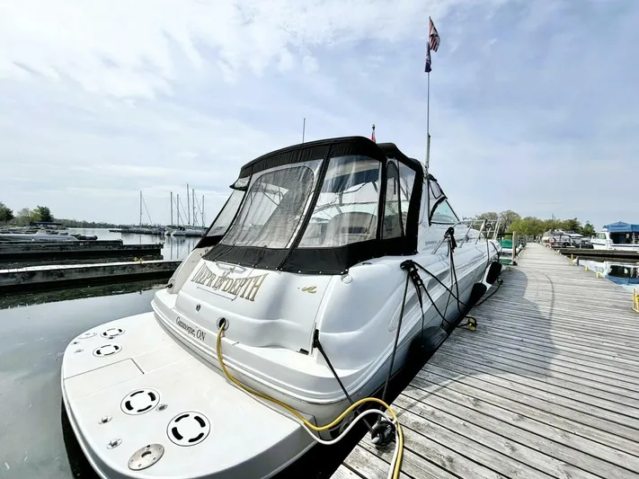  Yacht Photos Pics 2000 Sea Ray 410 Sundancer docked at marina, rear view with canopy.