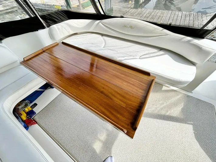  Yacht Photos Pics Interior of 2000 Sea Ray 410 Sundancer with wooden table and white seating.