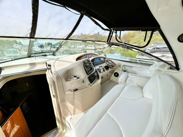  Yacht Photos Pics Interior view of a 2000 Sea Ray 410 Sundancer yacht cockpit with white seating.