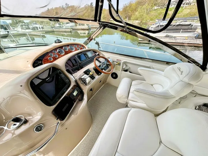  Yacht Photos Pics Interior view of 2000 Sea Ray 410 Sundancer yacht cockpit with luxurious seating and controls.