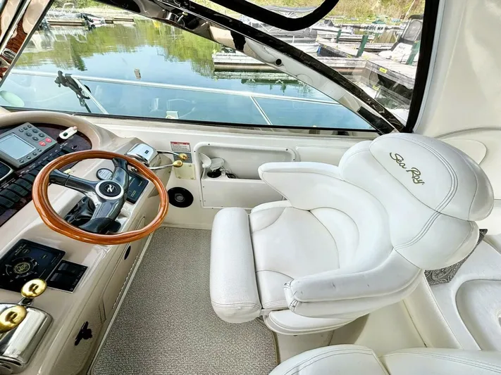  Yacht Photos Pics Luxurious helm of 2000 Sea Ray 410 Sundancer with plush seating and wooden steering wheel.