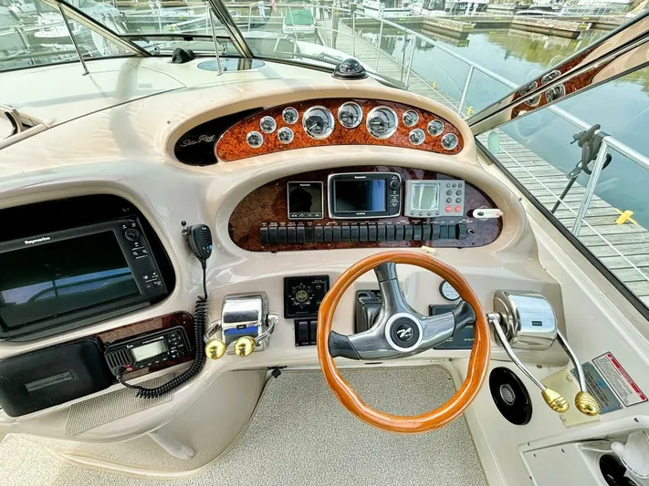  Yacht Photos Pics Cockpit of 2000 Sea Ray 410 Sundancer with steering wheel and navigation instruments.