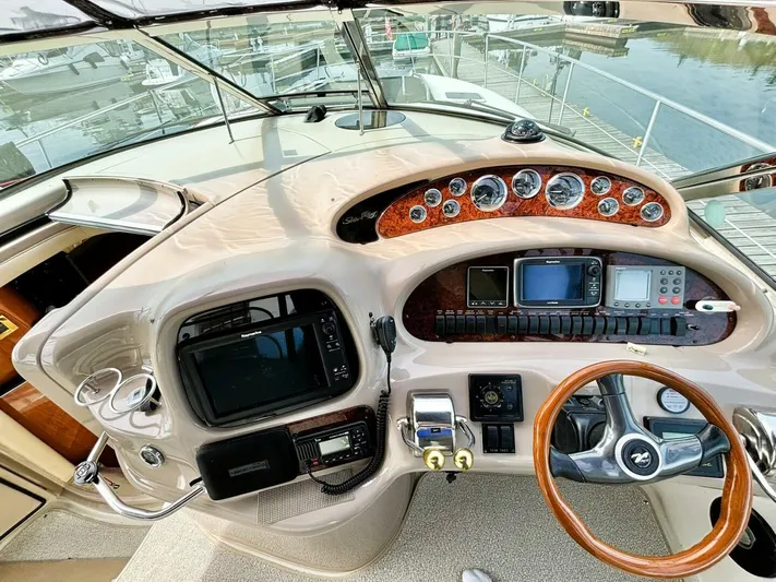  Yacht Photos Pics Cockpit of 2000 Sea Ray 410 Sundancer with navigation instruments and wooden steering wheel.