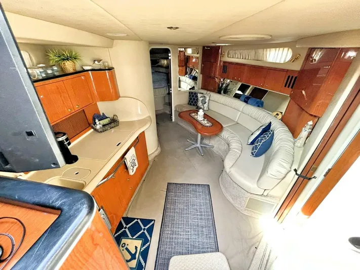  Yacht Photos Pics Interior of 2000 Sea Ray 410 Sundancer yacht with modern furnishings and cozy seating area.