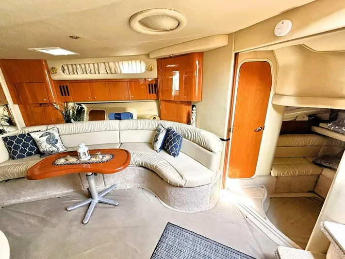  Yacht Photos Pics Luxurious interior of 2000 Sea Ray 410 Sundancer yacht with plush seating and wooden accents.