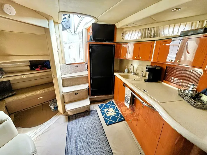  Yacht Photos Pics Interior of 2000 Sea Ray 410 Sundancer yacht with kitchen and seating area.