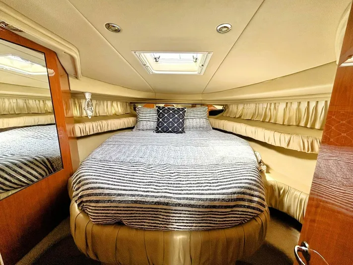  Yacht Photos Pics Luxurious cabin interior of 2000 Sea Ray 410 Sundancer yacht with cozy bed and elegant decor.