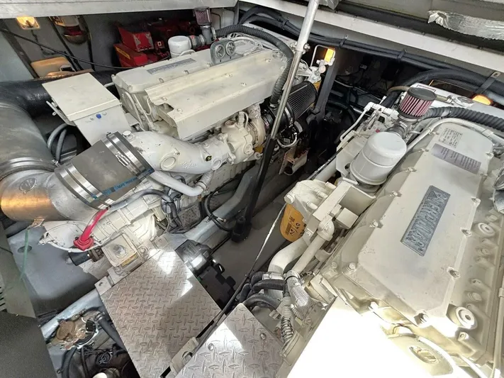 Yacht Photos Pics Engine room of a 2000 Sea Ray 410 Sundancer, showcasing dual engines and mechanical components.