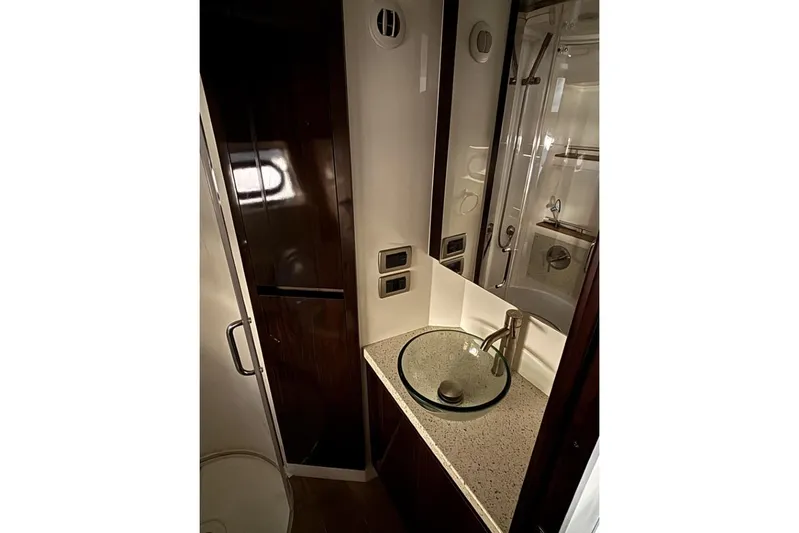 Seven Stars Yacht Photos Pics Luxurious bathroom in 2016 Sea Ray 400 Sundancer yacht with glass sink and modern fixtures.