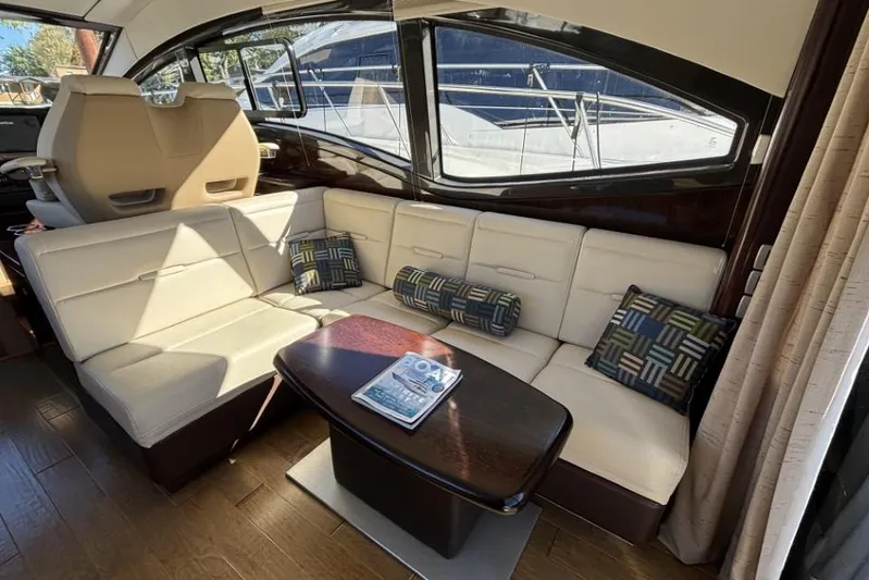 Seven Stars Yacht Photos Pics Luxurious interior of 2016 Sea Ray 400 Sundancer yacht with plush seating and table.