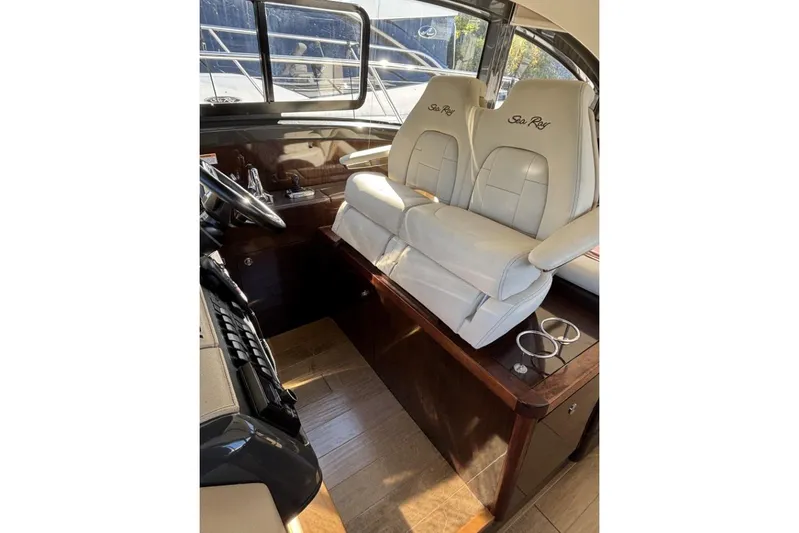Seven Stars Yacht Photos Pics Luxurious helm seating in 2016 Sea Ray 400 Sundancer yacht, featuring elegant white leather chairs.