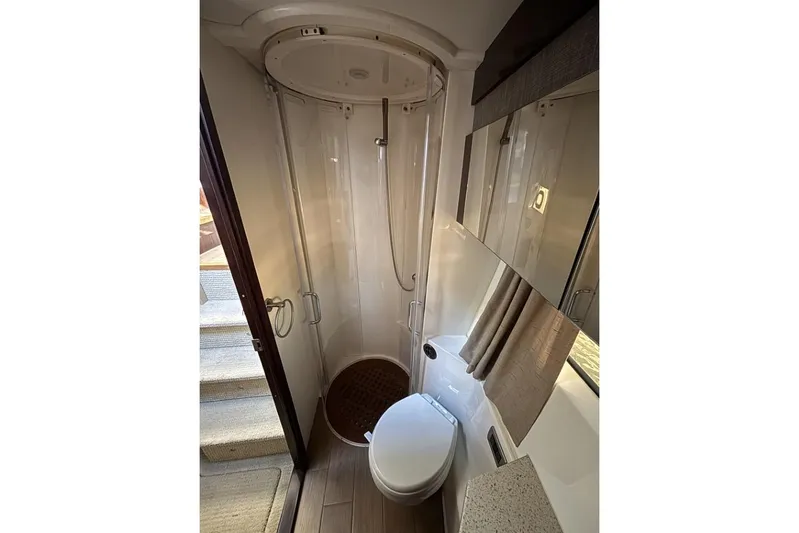 Seven Stars Yacht Photos Pics Bathroom interior of 2016 Sea Ray 400 Sundancer yacht, featuring shower and toilet.