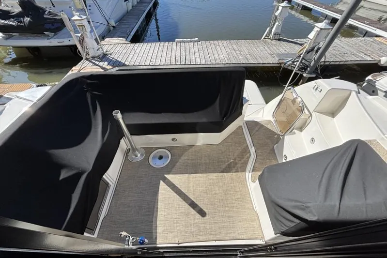 Seven Stars Yacht Photos Pics 2016 Sea Ray 400 Sundancer cockpit with black seating covers at marina dock.