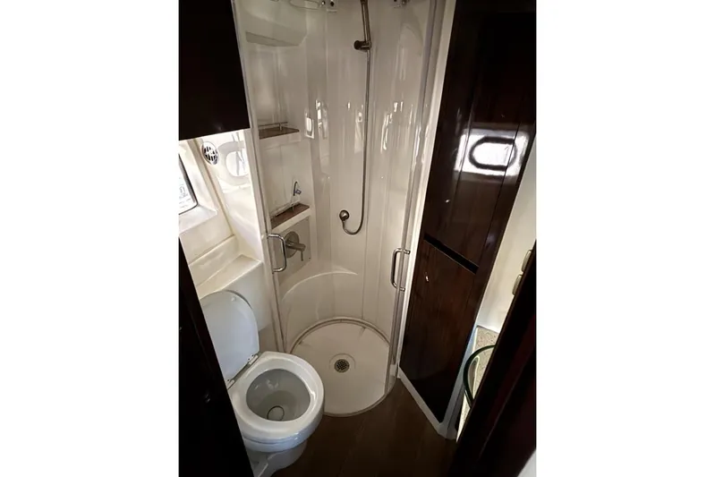 Seven Stars Yacht Photos Pics Bathroom interior of 2016 Sea Ray 400 Sundancer yacht with shower and toilet.