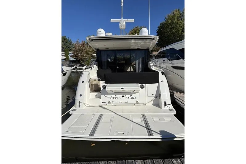 Seven Stars Yacht Photos Pics 2016 Sea Ray 400 Sundancer yacht docked, rear view with clear blue sky.
