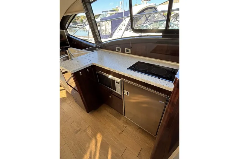 Seven Stars Yacht Photos Pics 2016 Sea Ray 400 Sundancer yacht kitchen with modern appliances and sleek design.