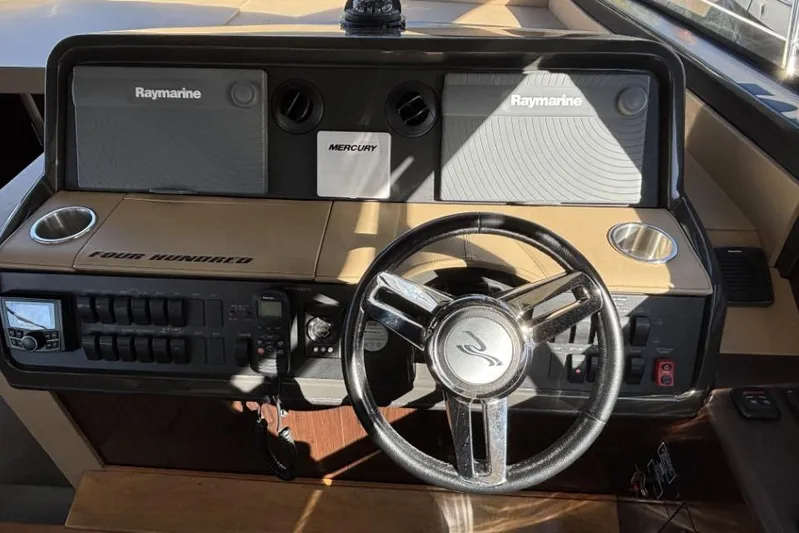 Seven Stars Yacht Photos Pics 2016 Sea Ray 400 Sundancer helm with Raymarine electronics and Mercury controls.