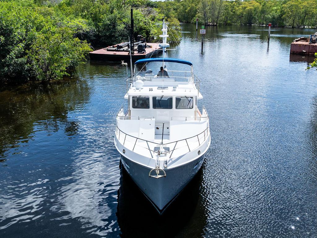 Selene Solo 2000 yacht on a serene river surrounded by lush greenery.