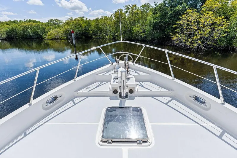  Yacht Photos Pics Bow view of 2000 Selene Solo yacht navigating a serene river with lush greenery.