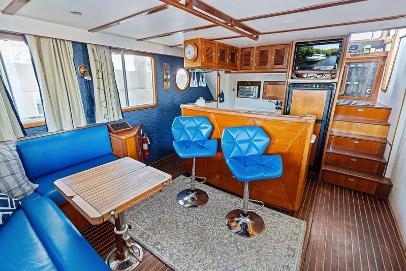  Yacht Photos Pics Luxurious Selene Solo 2000 yacht interior with blue seating, wooden accents, and modern kitchen area.